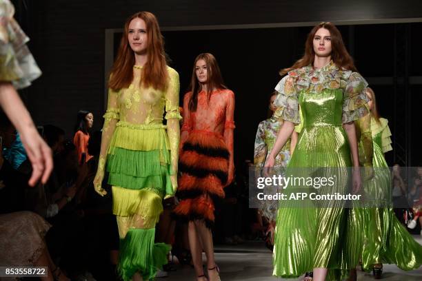 Models present creations for fashion house Daizy Shely during the Women's Spring/Summer 2018 fashion shows in Milan, on September 25, 2017. / AFP...