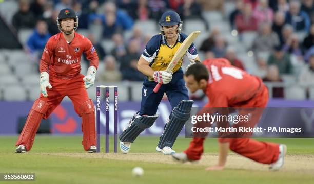 Birmingham Bears' Laurie Evans hits for 4 from the bowling of Stephen Parry , during the Natwest T20 Blast match at Old Trafford, Manchester.