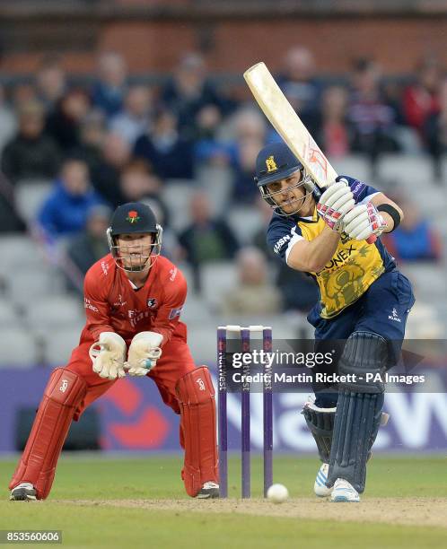 Birmingham Bears' Laurie Evans hits for 4 from the bowling of Stephen Parry , during the Natwest T20 Blast match at Old Trafford, Manchester.