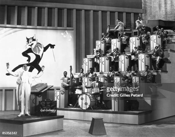 Photo of Cab CALLOWAY; Cab Calloway performing on stage, with band and cartoon cat on screen