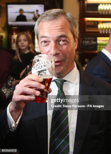 Ukip leader Nigel Farage has a pint in the Westminster Arms, London, as he celebrates his partys results in the polls for the European Parliament.