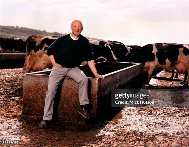 Photo of Michael EAVIS; Posed portrait of Glastonbury organiser Michael Eavis on his farm, with cows, 407
