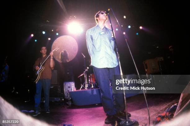 Photo of OASIS and Liam GALLAGHER and Paul Bonehead ARTHURS; Paul "Bonehead" Arthurs and Liam Gallagher performing on stage