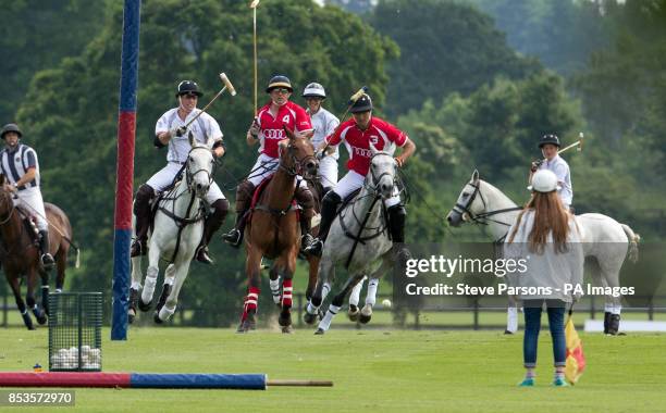 The Duke of Cambridge plays in a charity polo match during the second day of the Audi Polo Challenge at Coworth Park near Ascot, Berkshire as Prince...