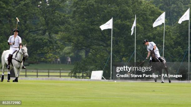 The Duke of Cambridge and Prince Harry during a charity polo match on the second day of the Audi Polo Challenge at Coworth Park near Ascot, Berkshire.