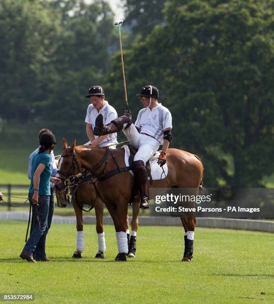 Prince Harry and the Duke of Cambridge during a charity polo match on the second day of the Audi Polo Challenge at Coworth Park near Ascot, Berkshire.