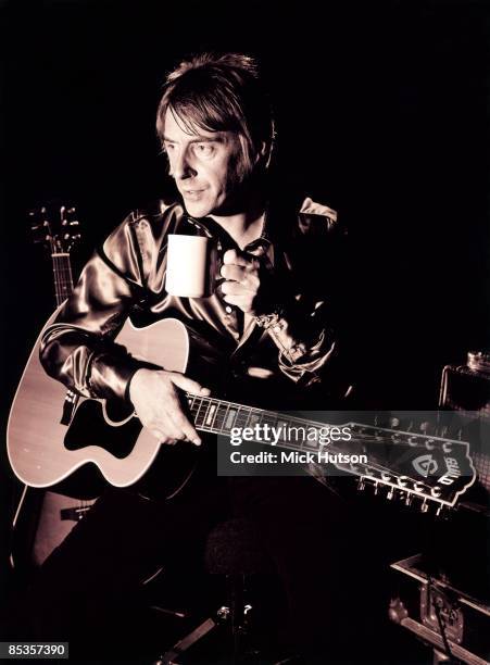 Photo of Paul WELLER; Posed portrait of Paul Weller with acoustic guitar and cup of tea, 409