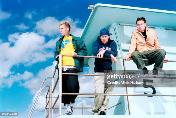 Photo of BLINK 182 and Travis BARKER and Tom DELONGE and Mark HOPPUS; Posed group full length portrait L-R Travis Barker, Tom DeLonge and Mark...