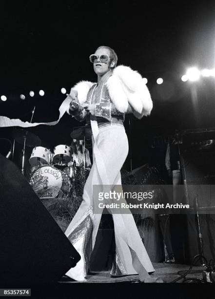 Photo of Elton JOHN; Elton John performing on stage, full length, fur