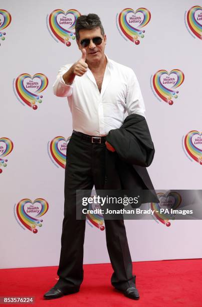 Simon Cowell arrives at the Savoy Hotel, London, to attend the Health Lottery Tea Party charity fundraiser.