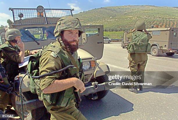 Israeli soldiers search for Palestinian gunmen as they patrol near the Palestinian village of Hawara March 25 shortly after a Jewish settler was shot...