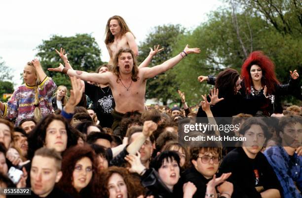 Photo of GOTH and CROWDS and FANS and FESTIVALS, goths, folk fans and crusties enjoy the music at the Fleadh festival, people sit on shoulders