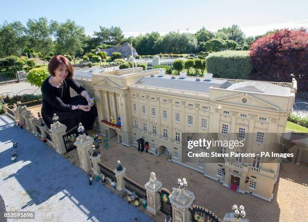 Royal Warrant of Appointment to Her Majesty The Queen Milliner Rachel Trevor Morgan puts the finishing touches to Legoland Windsor Resort's 10cm...