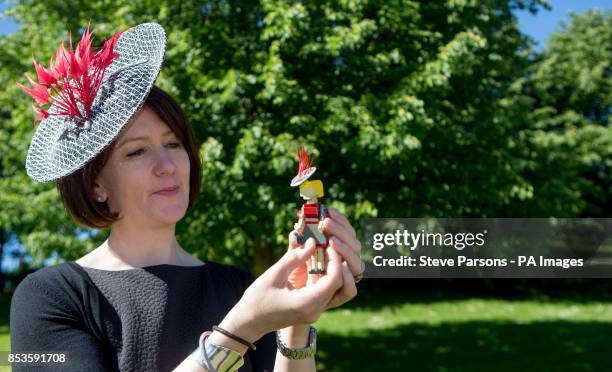 Royal Warrant of Appointment to Her Majesty The Queen Milliner Rachel Trevor Morgan puts the finishing touches to Legoland Windsor Resort's 10cm...