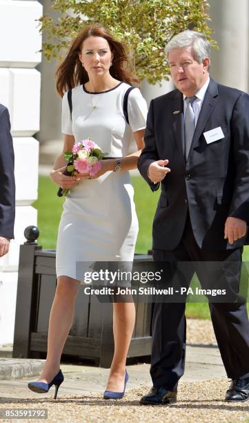 The Duchess of Cambridge talks to Sir Keith Mills, deputy chairman of the London Organising Committee of the Olympic and Paralympic Games, during a...