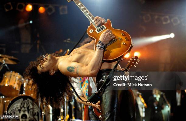 Photo of GUNS & ROSES and SLASH and GUNS N' ROSES and GUNS AND ROSES, Slash performing live onstage at the Freddie Mercury Tribute Concert, playing...