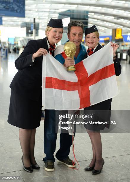 England fan Dave Raby from Gillingham poses with BA Cabin Crew Kimberley Lauf and Jane Lynch in departures at Terminal 5 at Heathrow before boarding...