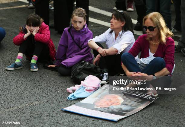 Mary Kelly Jane Conlon and her daughters Jane Higgins, eight, and Rhiana Higgins during a march and candlelit vigil from the Department of Children...