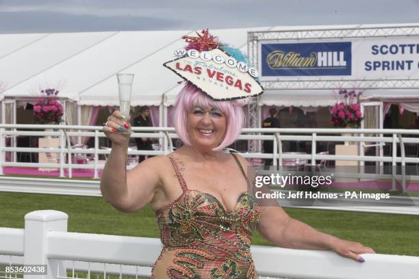 Racegoer Maggie Anderson arrives during Stobo Castle Ladies Day at Musselburgh Racecourse, East Lothian.