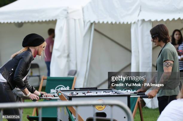 Anthony Kiedis of the Red Hot Chili Peppers playing table football backstage at the Isle of Wight Festival, in Seaclose Park, Newport, Isle of Wight.