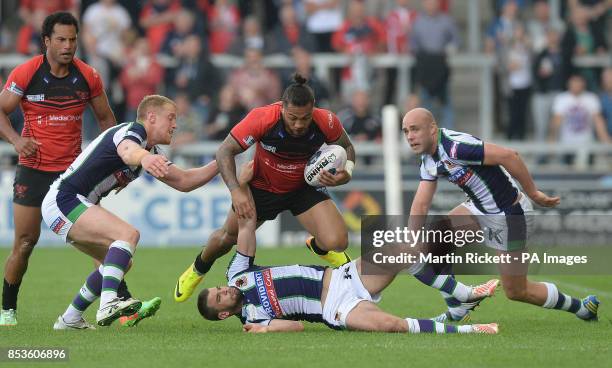 Salford Red Devils' Junior Sa'u is tackled by Bradford Bulls Tom Olbison Elliot Kerr and Adam Purtell during the First Utility Super League match at...