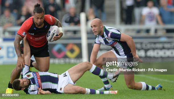 Salford Red Devils' Junior Sa'u is tackled by Bradford Bulls Elliot Kerr and Adam Purtell during the First Utility Super League match at Salford City...