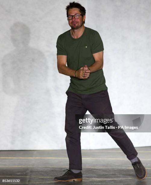 Oliver Spencer claps at the end of his catwalk show at the British Fashion Council's 2014 London Collections: Men fashion show at The Old Sorting...