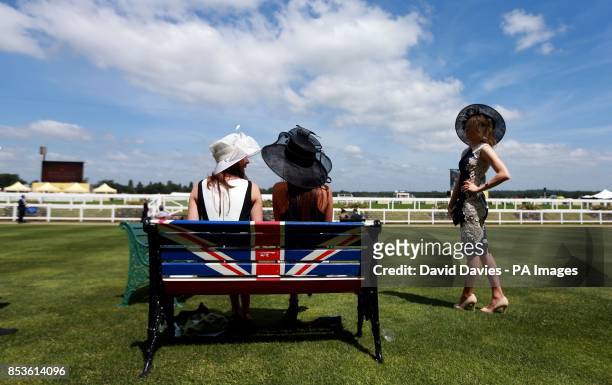 Ladies take a bench during Day One of the 2014 Royal Ascot Meeting at Ascot Racecourse, Berkshire.
