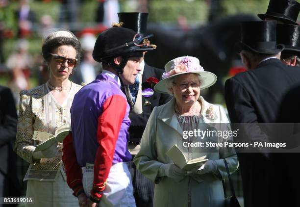 Queen Elizabeth II smiles as she chats to jockey Richard Hughes and trainer Richard Hannon during Day Two of the 2014 Royal Ascot Meeting at Ascot...