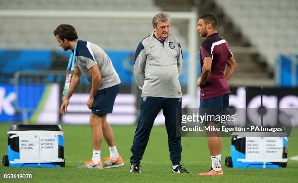 England manager Roy Hodgson speaks with Alex Oxlade-Chamberlain during a training session at the Estadio do Sao Paulo, Sao Paulo, Brazil.