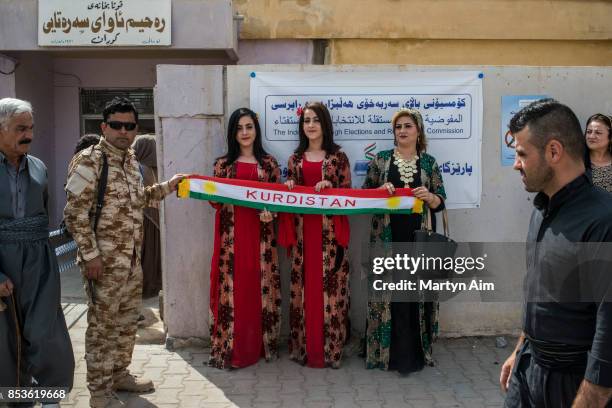 Kurdish women hold a banner at a referendum to decide on independence from Iraq and the establishment of Kurdistan as a state on September 25, 2017...