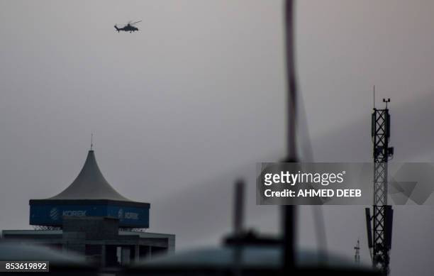 Picture taken on September 25, 2017 during the Kurdish independence referendum shows a Russian-made military attack helicopter flying over Arbil, the...