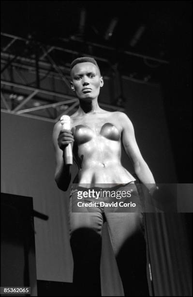Grace Jones performs at Drury Lane Theatre, London on 10th October 1981. She is wearing a breastplate designed by Issey Mikyake.
