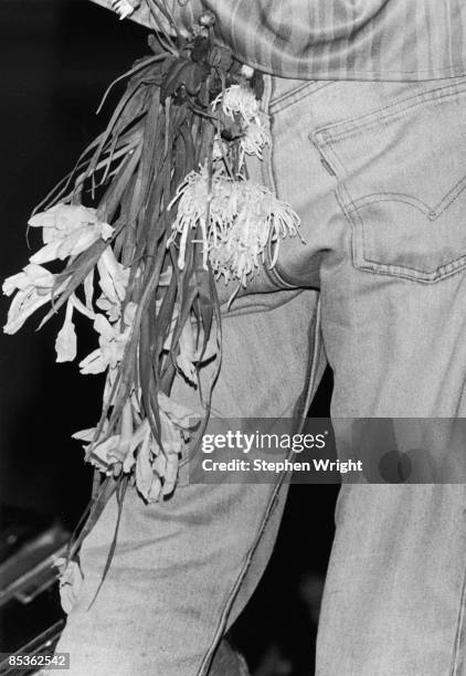Photo of MORRISSEY and The Smiths; Morrissey performing live onstage - flowers hanging from pocket of jeans -