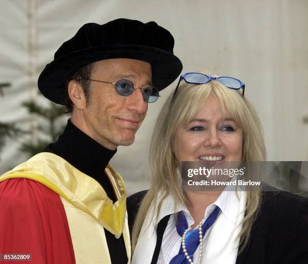 Photo of BEE GEES; Accepting honorary music doctorates @ Manchester University