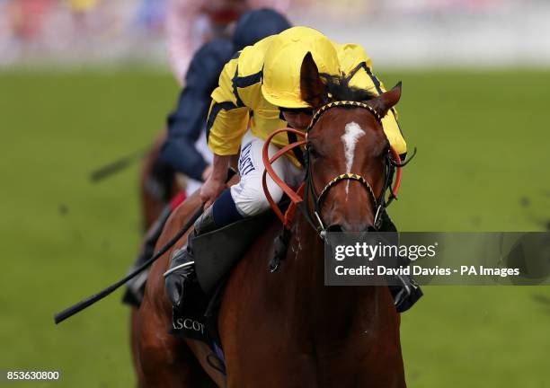 Rizeena ridden by Ryan Moore on their way to victory in the Coronation Stakes during Day Four of the 2014 Royal Ascot Meeting at Ascot Racecourse,...