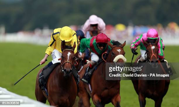 Rizeena ridden by Ryan Moore on their way to victory in the Coronation Stakes during Day Four of the 2014 Royal Ascot Meeting at Ascot Racecourse,...