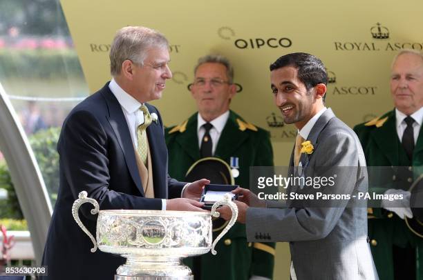 Prince Andrew congratulates owner Sheikh Rashid Dalmook Al Maktoum after Rizeena's victory in the Coronation Stakes during Day Four of the 2014 Royal...