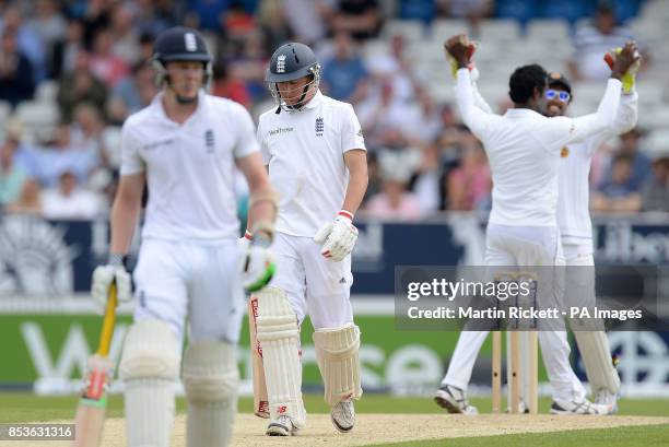 England's Gary Ballance leaves the wicket as Sri Lanka's Dinesh Chandimal and Angelo Matthews celebrate his wicket, during day two of the second...