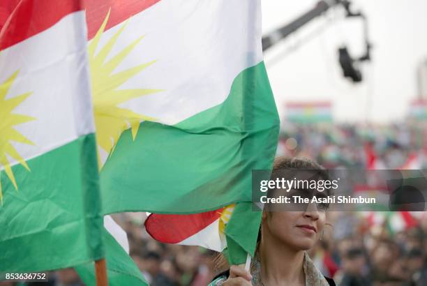 Female supporter waves the Kurdish flag during a rally for the upcoming referendum for independence of Kurdistan on September 22, 2017 in Erbil,...