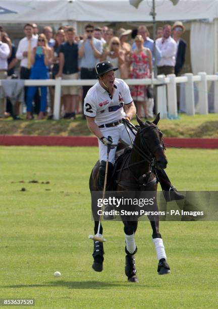 Prince Harry playing for Piaget competes in the Goldin Group Charity Polo during the Gloucestershire Festival of Polo at the Beaufort Polo Club near...