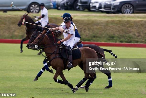 Prince Harry playing for Piaget competes in the Goldin Group Charity Polo during the Gloucestershire Festival of Polo at the Beaufort Polo Club near...