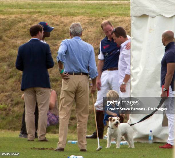 The Duke of Cambridge puts his arm around Peter Phillips after competing in the Goldin Group Charity Polo during the Gloucestershire Festival of Polo...