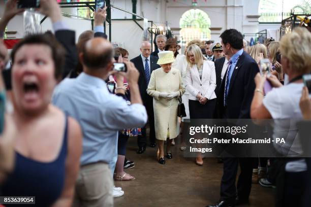 Queen Elizabeth II and the Duke of Edinburgh arrive at St. Georges Market in Belfast, on day two of their visit to Northern Ireland.