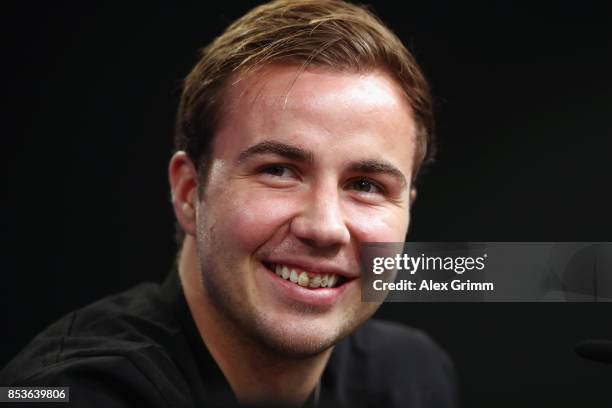 Mario Goetze smiles during a Borussia Dortmund press conference ahead of their UEFA Champions League Group H match against Real Madrid at Signal...