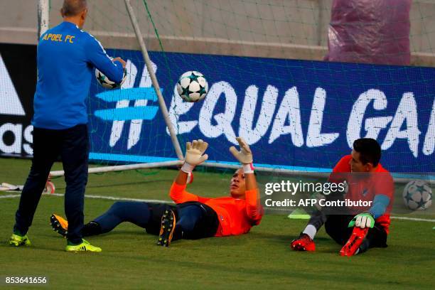 Apoel's Mexican goalkeepers Raul Gudino and Dutch Boy Waterman take part in a training session at the GSP Stadium in Nicosia, on the eve of the UEFA...