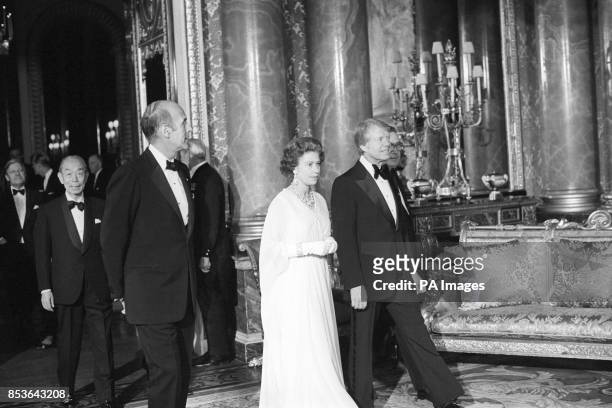 Queen Elizabeth II, flanked by President Jimmy Carter and President Giscard d'Estaing in the Blue Drawing Room at Buckingham Palace, where world...