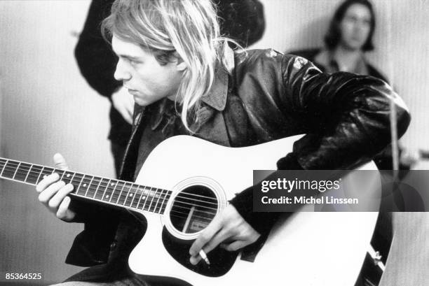 Photo of Kurt COBAIN and NIRVANA, Kurt Cobain recording in Hilversum Studios, playing Takamine acoustc guitar, holding cigarette