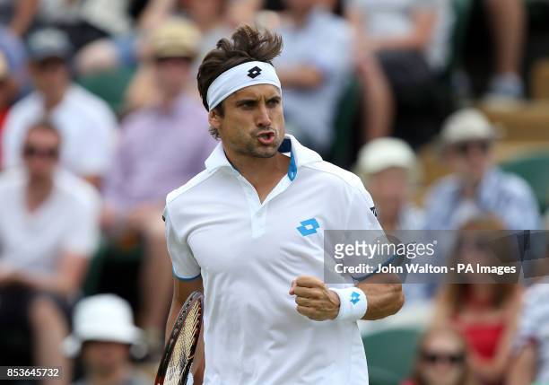 Spain's David Ferrer celebrates a point against Russia's Andrey Kuznetsov during day three of the Wimbledon Championships at the All England Lawn...