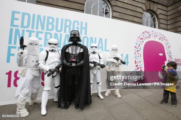 Young boy Star Wars character Darth Vader with Stormtroopers and Snowtroopers at Edinburgh Castle ahead of a screening of Star Wars Episode V The...